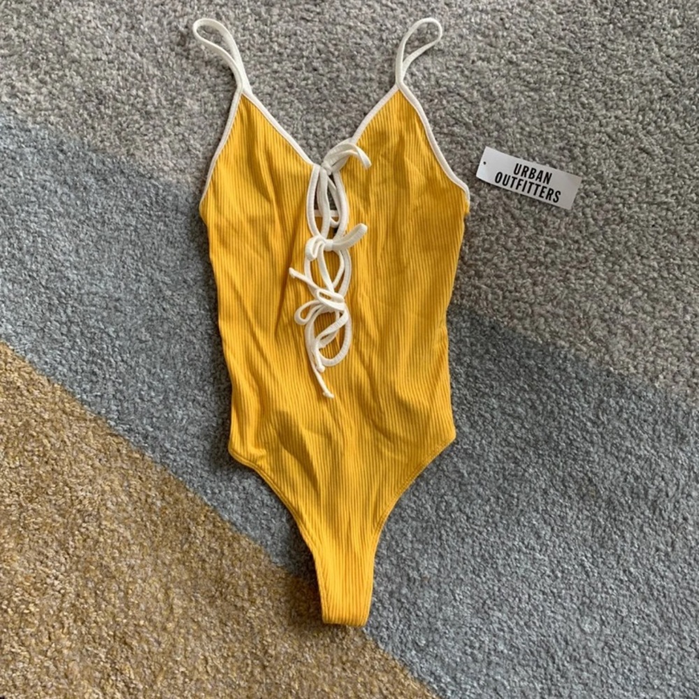 Yellow and white body suit onesie